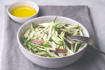 Puntarelle alla romana or asparagus Catalonian chicory salad with anchovy dressing and olive oil, italian food, selective focus, close-up. Italian traditional seasoning recepies 