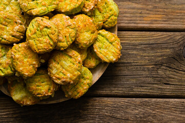 homemade baked scone cakes from fresh ramson leaves and cheese, old wooden texture
