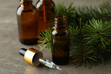 Aromatherapy concept with pine oil on gray table