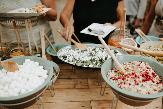 People taking food from a buffet