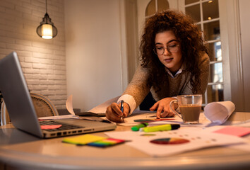 Fototapeta premium Young woman working at home having video call on laptop.