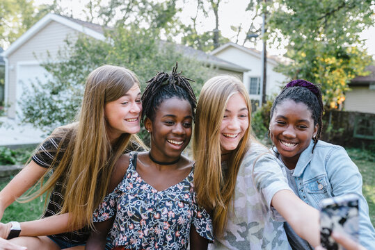 Group of diverse teenage girls with mobile devices