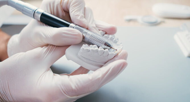 Dental Technician Making New Dental Prosthetics in Laboratory.