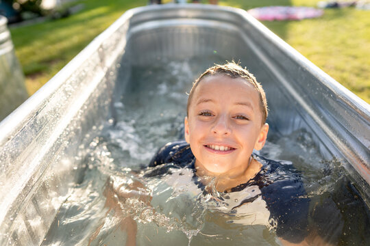 Smiling boy swims in pool