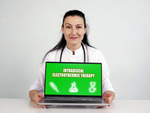  INTRADISCAL ELECTROTHERMIC THERAPY IDET inscription on the screen. Close up internisthands holding pen.