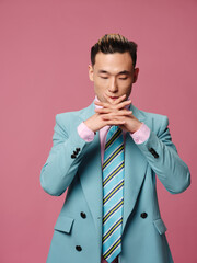 Business man holding hands in front of him pink background cropped view of manager