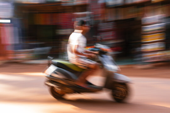 Traffic in India. Intentionally blurred motion of a motorbike.