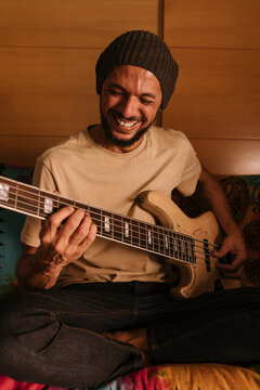 Cheerful ass player rehearsing at home.