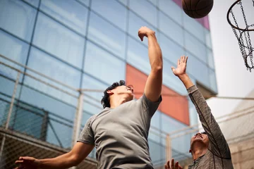 Fotobehang two young asian men playing basketball © imtmphoto