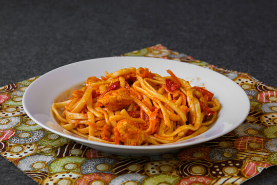 Spaghetti Pasta With Red Sauce And Meat. A Served Platter With Food On The Dining Table.