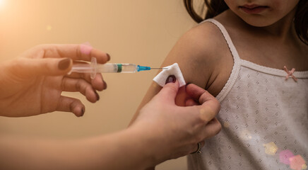 Doctor vaccinates child to stop coronavirus and other pandemic diseases. Concept fight against...