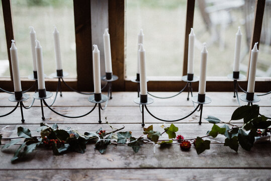 Table decorated for Christmas with white candles and ivy