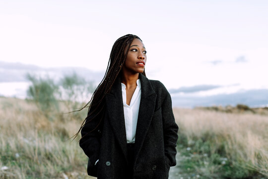 Woman with braided hairstyle outdoors.