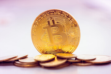 golden bitcoin on the background of a heap of other coins