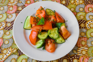 Cucumber and tomato salad. Vegetable food on a platter.