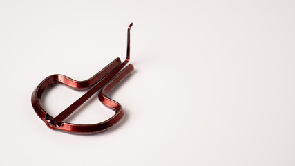 Red vargan or drymba on white background. Jaw harp, mouth harp, gewgaw, guimbard, khomus, trump.