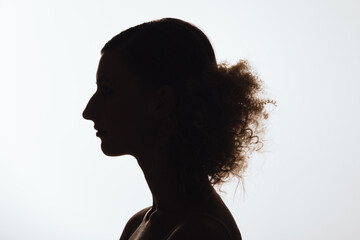 Silhouette of anonymous woman with curly hair