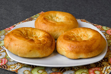 Baked crumpets on a platter. High-calorie delicious pastries.