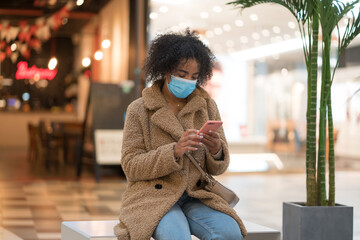 Woman With Protective Mask Using Smartphone