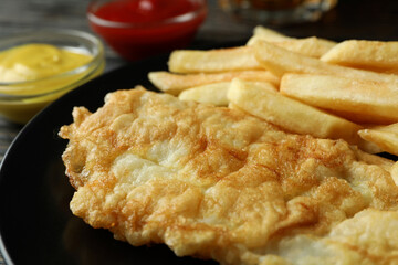 Plate with fried fish and chip, close up