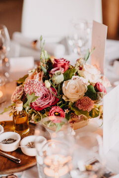 Beautiful table set indoors for reception with flower arrangement in the middle