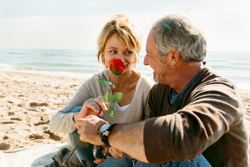 Fototapeta premium in love mature couple sitting at the beach