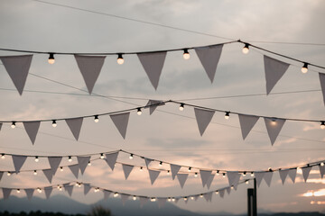 White bunting flags with string lights