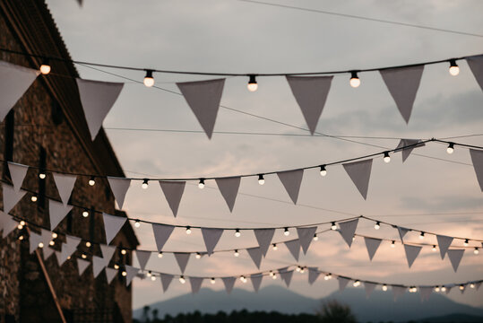 White bunting flags with string lights