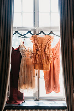 bridesmaids dress hanging in a window sill