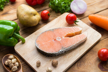 Cooking salmon steak with salad. Homemade fresh fish for healthy and diet food.