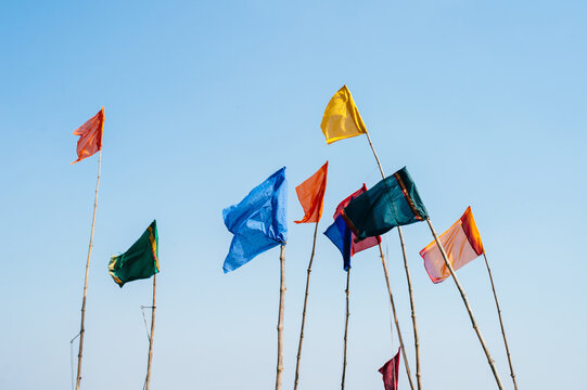Multiple flags rise above Varanasi in the sky