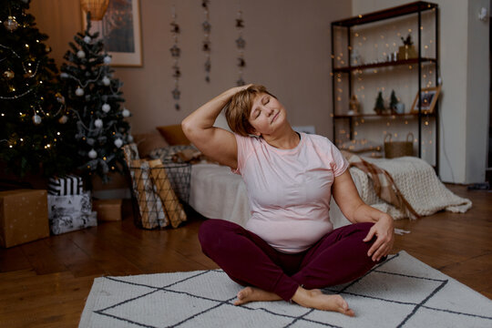 adult yoga woman coach doing christmas yoga at home