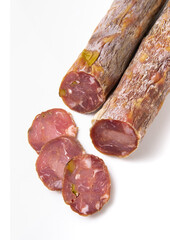Dried sausage sliced into slices on a white plate. Elite meat product