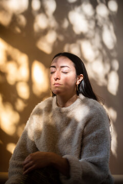 Portrait of woman in dappled light.