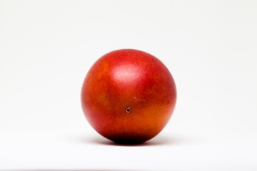 Ripe and juicy tamarillo fruit isolated in white