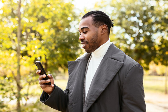 Black guy using smartphone in park