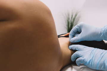 Hands puncture a needle on a patient nape