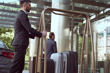 Hotel concierge is responsible for greeting guests and carrying their luggage © Yakobchuk Olena
