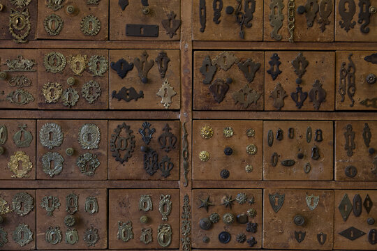 wooden drawers with antique keyhole plates replica put on display