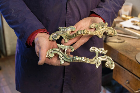 Artisan showing brass artifacts