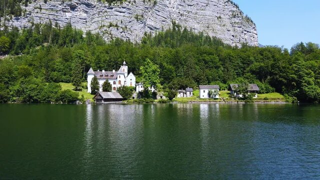 Summer rural landscape with lake and white house in Hallstatt, Upper Austria. European alps and Hallstatter lake in Salzkammergut region