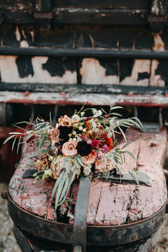 Romantic bohemian wedding bouquet with red, pink and orange tones