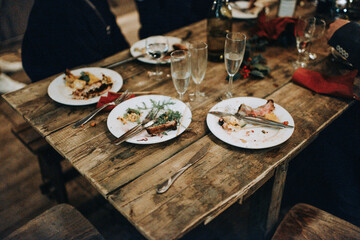 Rustic wooden table with leftovers from a Christmas dinner