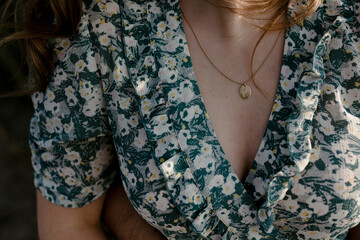 close up of girl wearing a beautiful dress and necklace with name of child 'Jule'