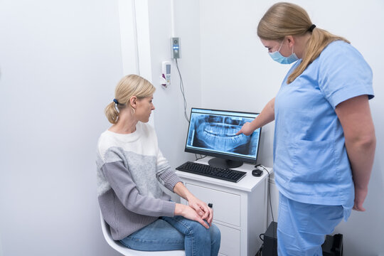 Dentist And Patient Analyze X-Ray