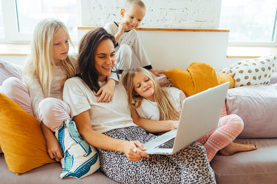 Mother and children watching movie together at home