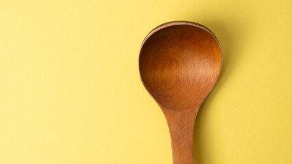 wooden spoon on green background