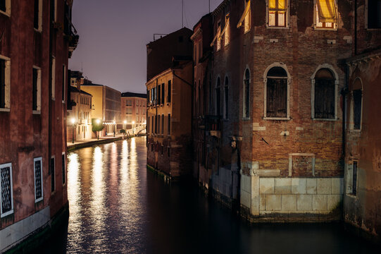 Colourful Venice Canal with bridge and boat