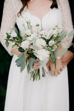 Bohemian Indie Bride in cute romantic wedding dress with wedding bouquet