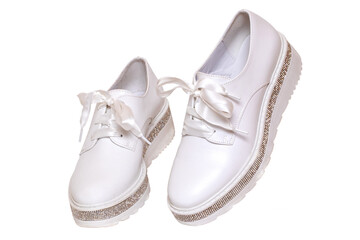 White sneaker isolated. Close-up of a pair white elegant stylish female leather high-heeled sport shoes isolated on a white background. Womens shoe fashion 2020. Modern design footwear for workout.